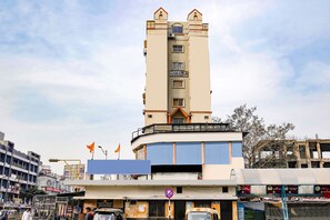 A multi-story building with a sign indicating it is a hotel. - Fabexpress A1 Residency (Ahmedabad)