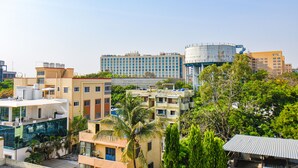 A hotel with multiple floors, balconies, and a modern design. - FabHotel Prime Esta Inn - Nr. Novotel Pune Nagar Road, Viman Nagar (Pune)