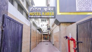 A narrow alleyway leading to Hotel Kuber, with a signboard in both Hindi and English. - FabHotel Kuber (Navi Mumbai)