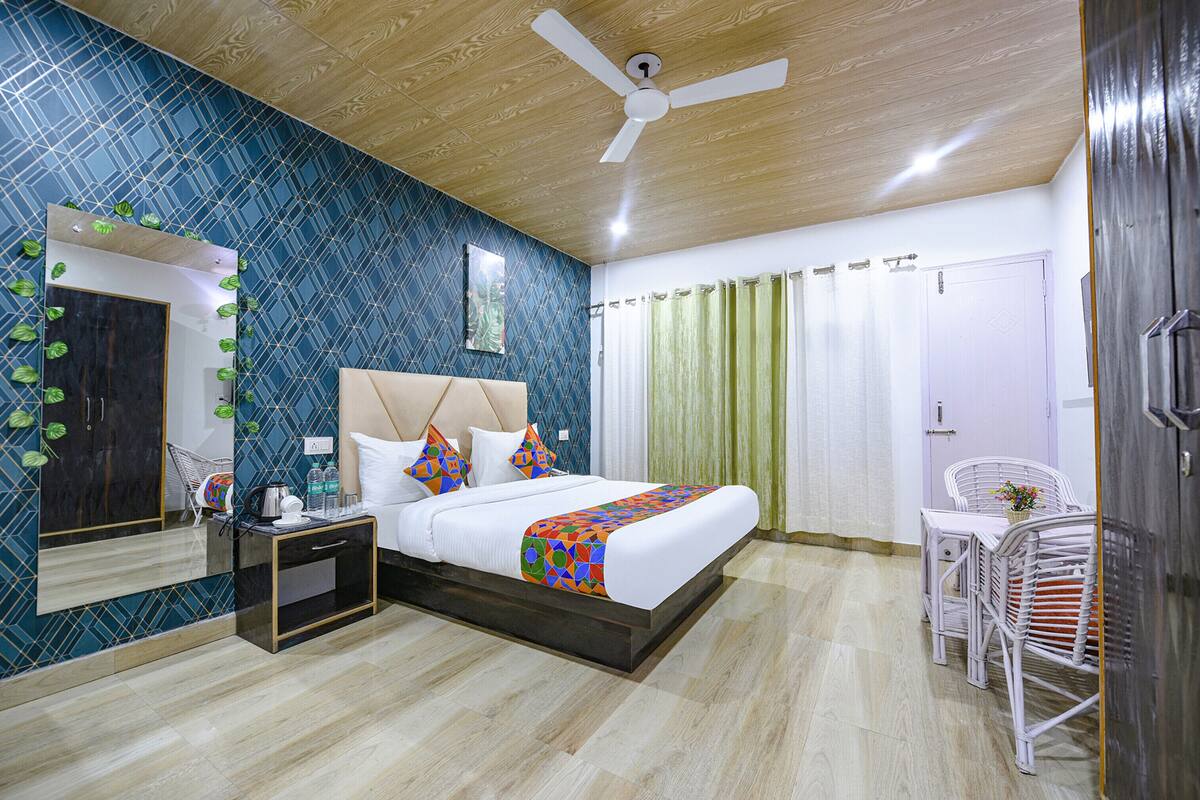 A bedroom with a bed, bedside table, and a chair.