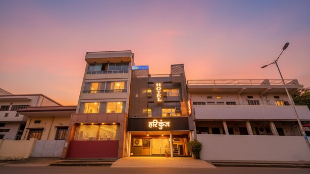A hotel with a modern design, featuring a prominent 'HOTEL' sign and a sign in a local language. - FabHotel Hari Kunj 900 m from Kashi Vishwanath Temple (Varanasi)