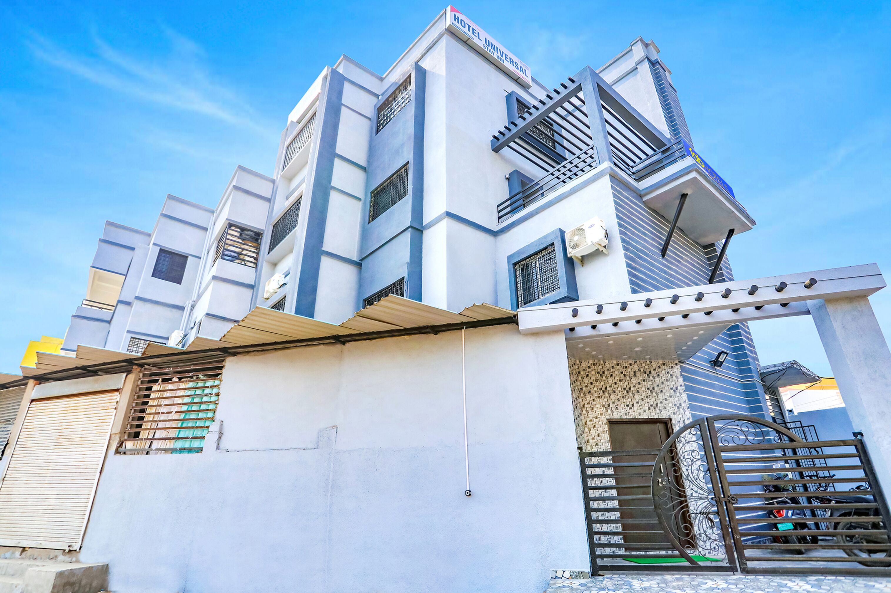 Un hôtel moderne, reconnaissable à son enseigne bien visible, doté de nombreux balcons et d’une entrée sécurisée par un portail.