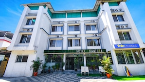 A hotel with a checkered entrance, multiple balconies, and air conditioning units. - Fabhotel Prime Kantara (Mawal)
