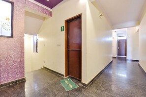Enter a welcoming space with a polished floor and vibrant walls, leading to a door marked '1'.