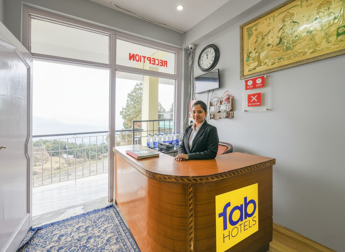 A reception desk at Fab Hotels with a view of the outdoors.