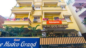 A multi-story hotel named 'The Hudco Grand' with balconies decorated with pink and yellow ribbons. - FabHotel The Hudco Grand (Patna)