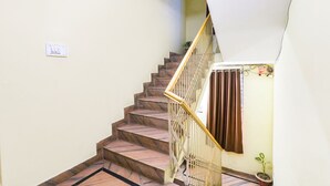 A staircase with marble steps and a metal railing. - FabHotel The Hudco Grand (Patna)