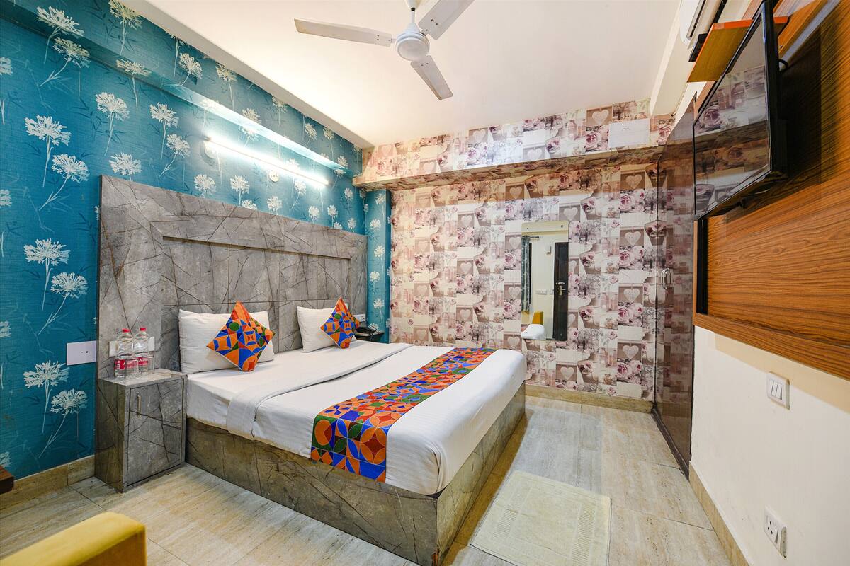 A bedroom with a bed, nightstand, and a ceiling fan.