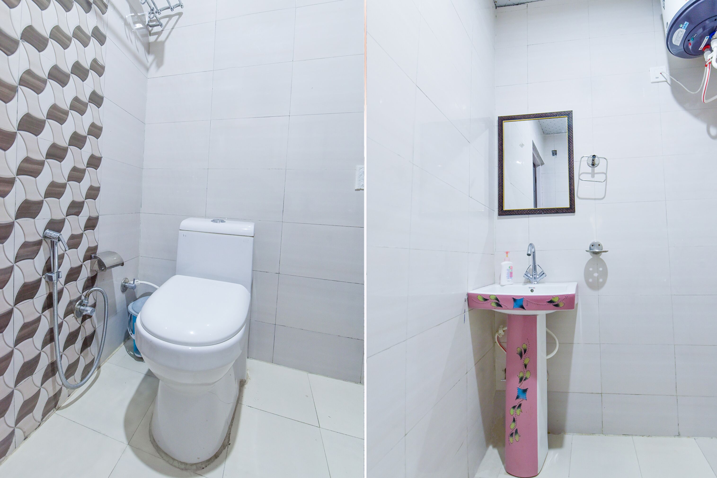 A bathroom with a toilet, a shower, and a sink with a mirror.