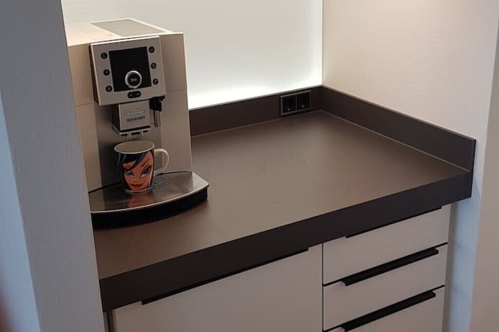 A coffee machine with a cup on the counter.