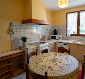 Compact kitchen with central island, sink, and appliances for daily tasks.