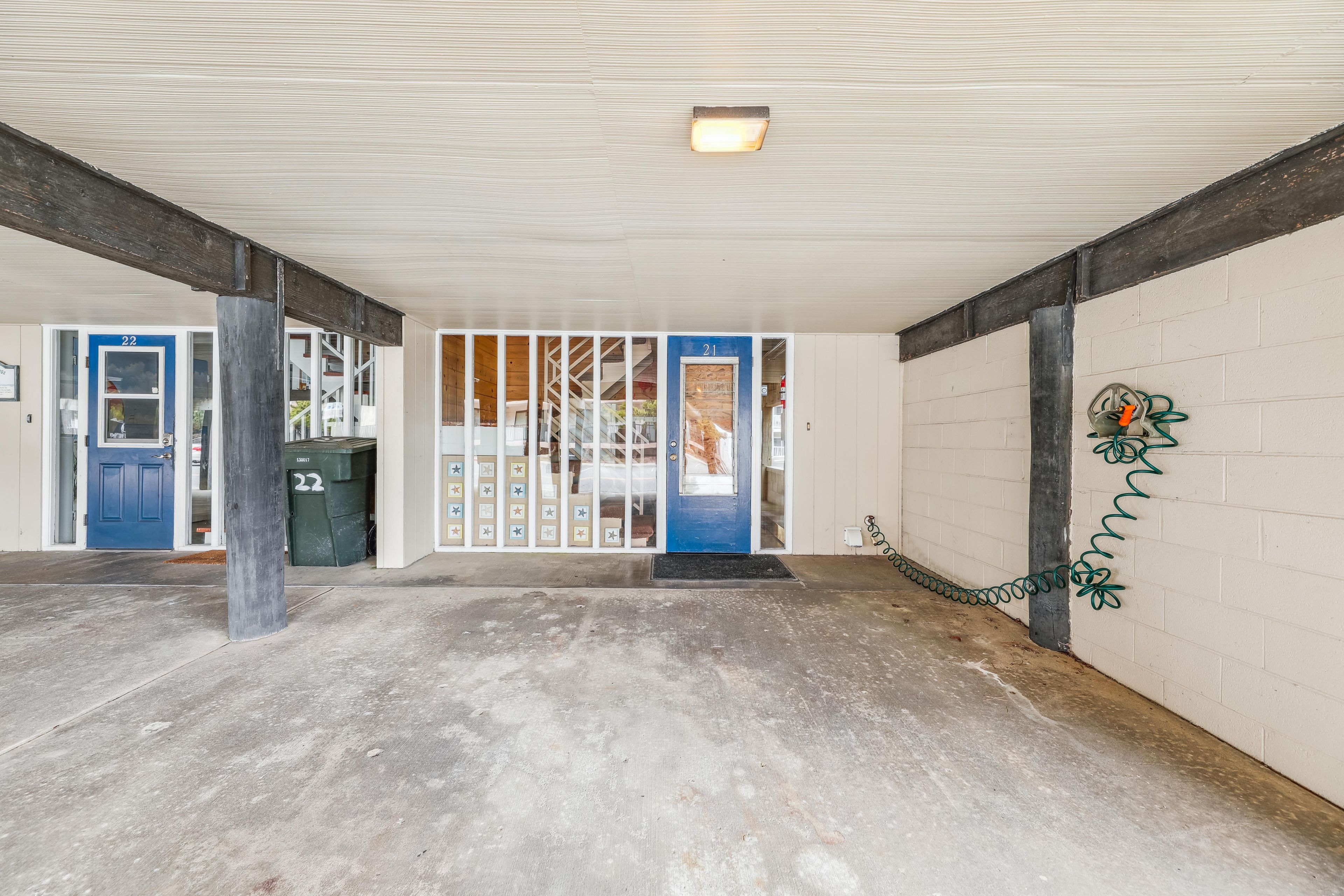 An empty hallway with a blue door labeled '21' and a blue door labeled '22'.