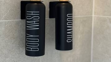 Bathtub, hair dryer, towels, toilet paper