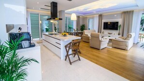 A modern living room with a central island, a dining area, and a seating arrangement. - Villa Visnja - Private villa with pool, Dalmatia (Stikovica)