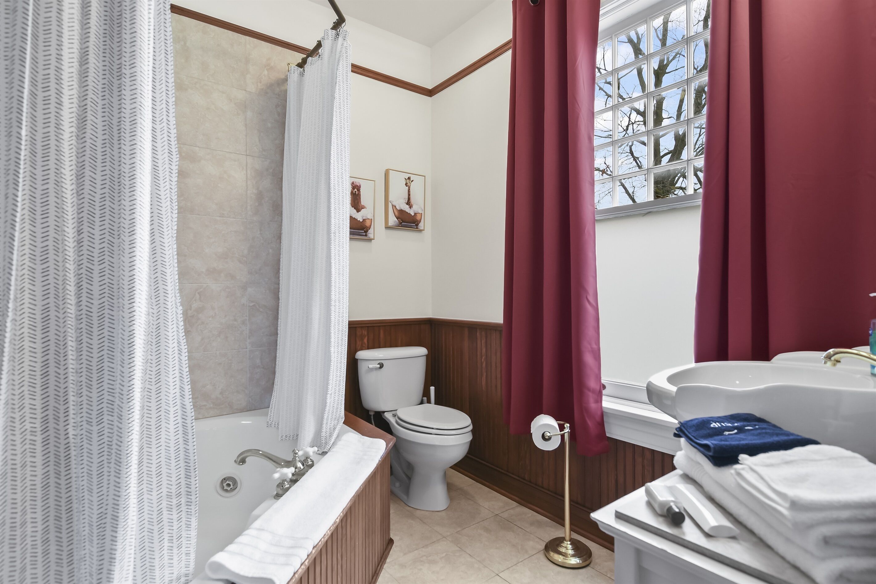 A bathroom with a bathtub, toilet, and sink.