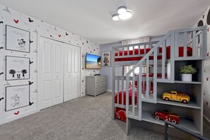 A child's bedroom with a bunk bed, a television, and Mickey Mouse-themed decorations. - 5 Bed In Champions Gate, Modern Decor, Kid Themed Rooms, Game Room, Gated Resort! 5 Bedroom Home by RedAwning (Davenport)