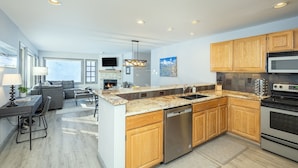 A modern kitchen with wooden cabinets, a built-in oven, and a dishwasher. - Etta Place 111 2 Bedroom Condo by RedAwning (Telluride)