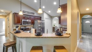 A kitchen with granite countertops, stainless steel appliances, and pendant lighting. - Ocala Retreat: 4 Mi to World Equestrian Center! (Ocala)