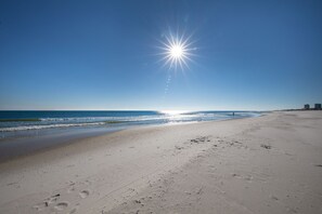 A beach with footprints and a clear sky. - Sanibel 606 (Gulf Shores)