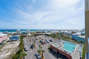 A resort with a swimming pool, beach access, and multiple buildings. - Sanibel 606 (Gulf Shores)
