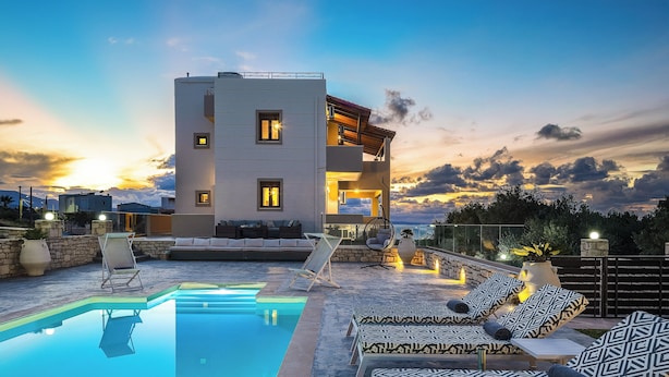 A modern building with a pool, outdoor seating, and a sunset view. - Villa Aris: A Serene Experience, 3BRs, Pool & Bbq (Rethymno)