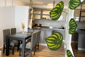 A modern kitchen with a dining area.