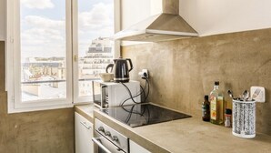 A kitchen with a view of the city, a toaster, a kettle, and a stove. - Splendid apartment with Eiffel Tower view / best for Olympic Games in Paris (Paris)