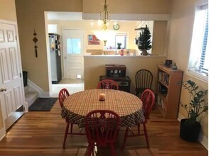 Cozy dining area with a round table and four chairs, featuring a warm ambiance.
