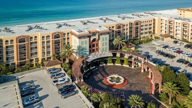 A hotel with multiple floors, a central courtyard, and a beach view. - Azure 319 - Beachfront Condo w/ Coastline Views - Free Seasonal Beach Service (Fort Walton Beach,)