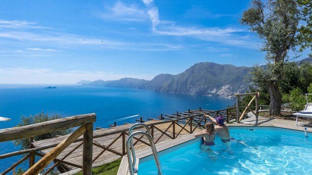 A wooden deck overlooking a swimming pool with a view of the sea and mountains. - Punta di Diamante - 200 Steps to Heaven (Praiano)