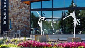 A performing arts center with a stone facade and large glass windows. - Skywalk Flats Mountainview Condo: Downtown, Rooftop Hot Tubs (Silverthorne)