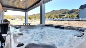 A hot tub with a view of a mountainous landscape through large windows. - Perfect Getaway nestled at the base of Brian Head (Parowan)