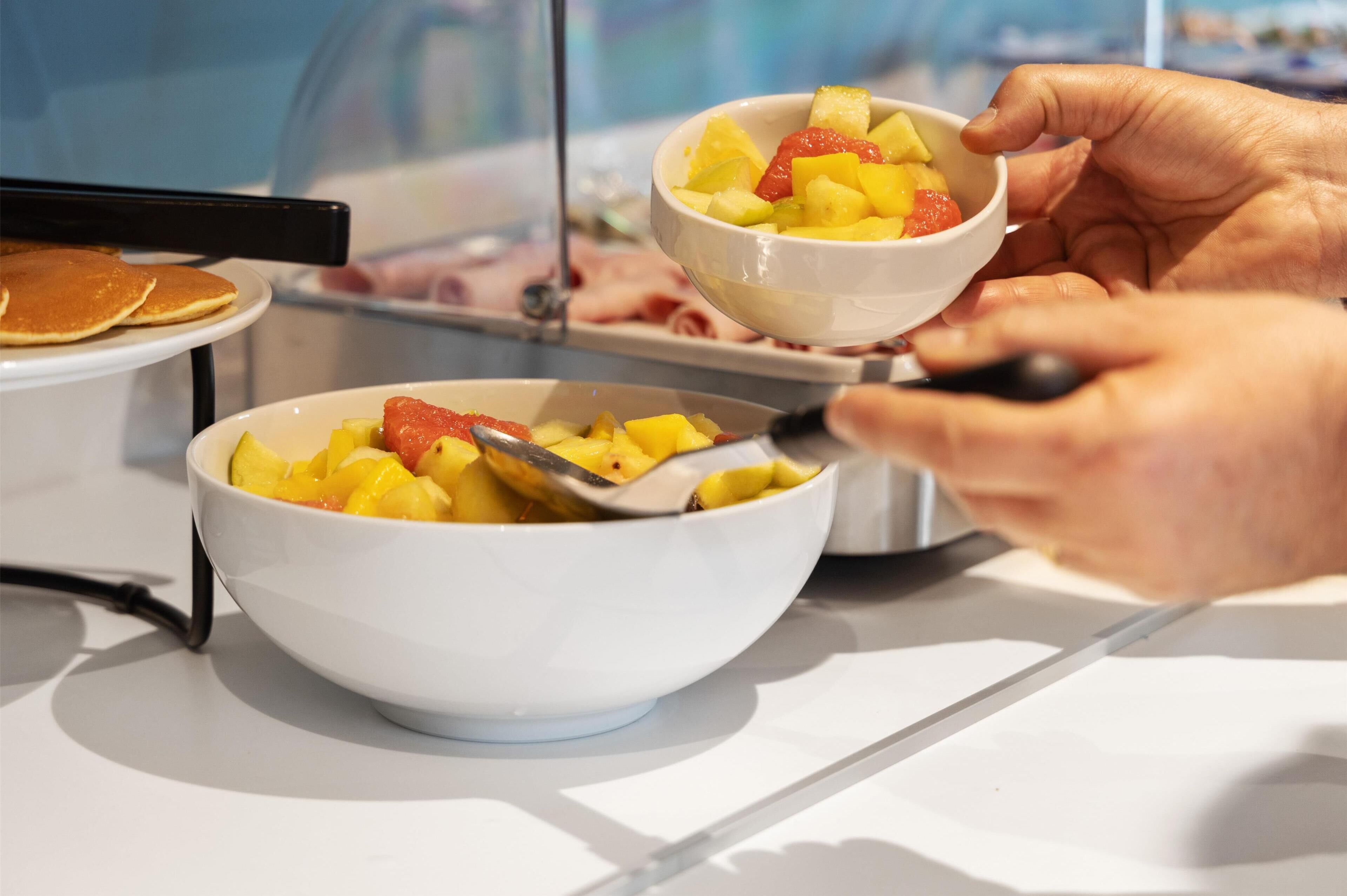 En person som serverar frukt från en skål.