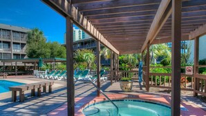 A pool area with lounge chairs and a hot tub. - Tilghman 146- 3BR Condo- Close to Main St (North Myrtle Beach)