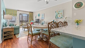 A dining area with a round table, chairs, and a ceiling fan. - Tilghman 146- 3BR Condo- Close to Main St (North Myrtle Beach)