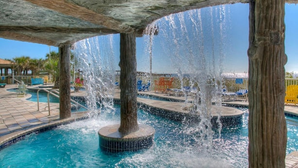 A pool area with multiple water features, including fountains and a central pool.