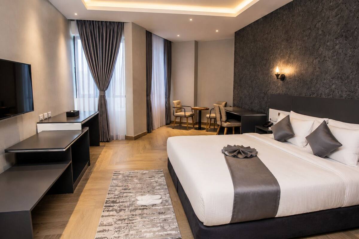 Deluxe Studio, Balcony, City View | In-room safe, desk, laptop workspace, blackout curtains