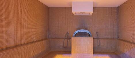 A spa room with a tiled floor, a central bench, and a wall-mounted heater.