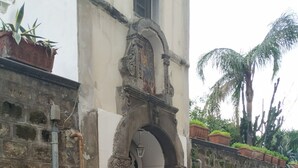 A building with a stone facade, an arched entrance, and steps leading to a door. - Suite 1744 (Meta)
