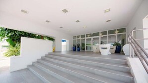 A modern interior with a staircase leading to a reception area. - Steps from Beach 2 Bed 2 Full Bath w/PK  @ ESJ (Carolina)