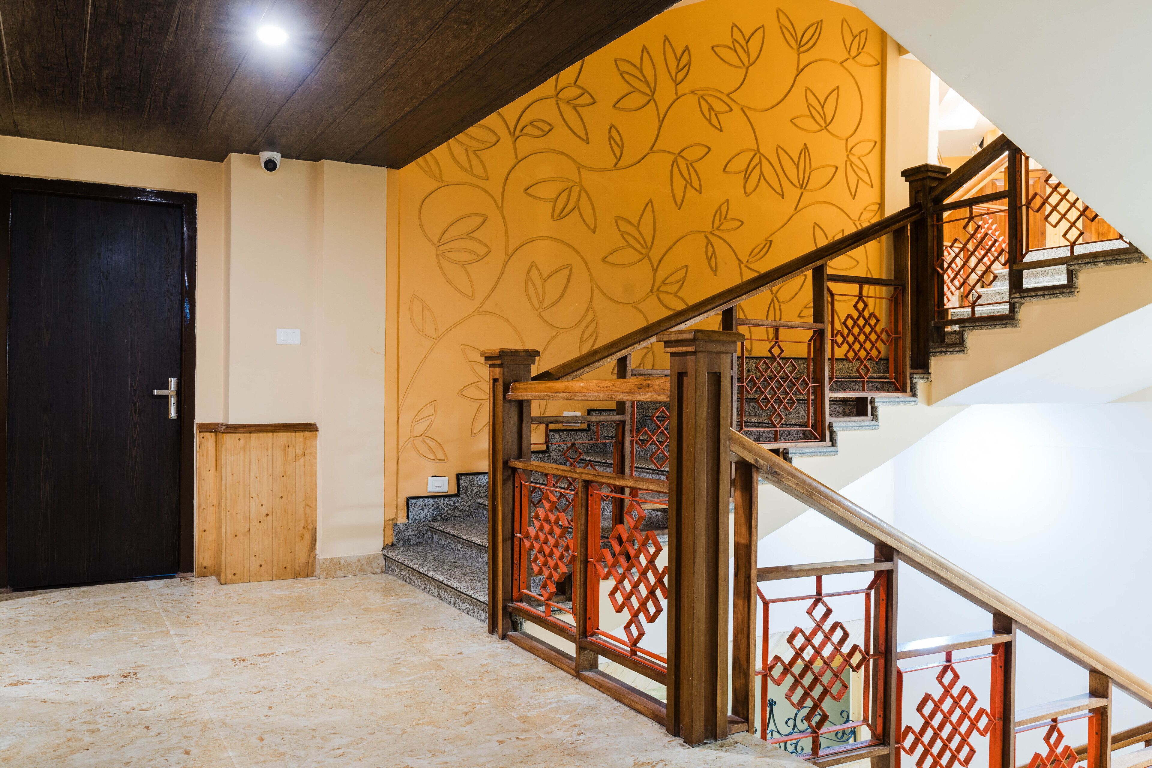 A staircase with wooden railings and a patterned wall.