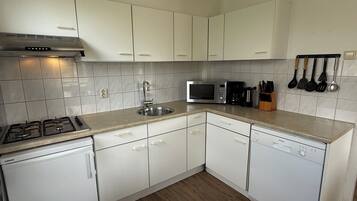 Fridge, stovetop, dishwasher, coffee/tea maker