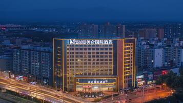 A hotel with a modern design, featuring a prominent entrance and multiple floors.