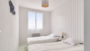 A bedroom with two beds, a window, and a bedside table with a lamp. - 250m from the beach - Loggia - Flat for 4 (Saint-Hilaire-de-Riez)