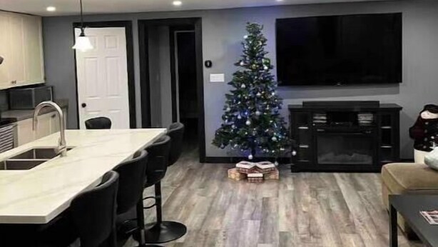 A modern kitchen with a bar area, a dining table, and a Christmas tree. - The south Bruce peninsula beauty (Wiarton)