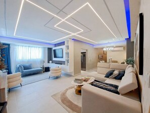 A modern living room with a sofa, coffee table, and TV.