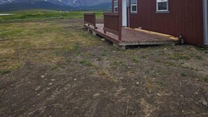 A small, single-story wooden building with a porch, set against a backdrop of mountains and cloudy sky. - Rising Wolf Cabin
Glacier National Park
Centralized location for exploring (East Glacier Park)