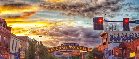 A street scene with a 'Welcome to Golden' sign, buildings, and traffic lights.