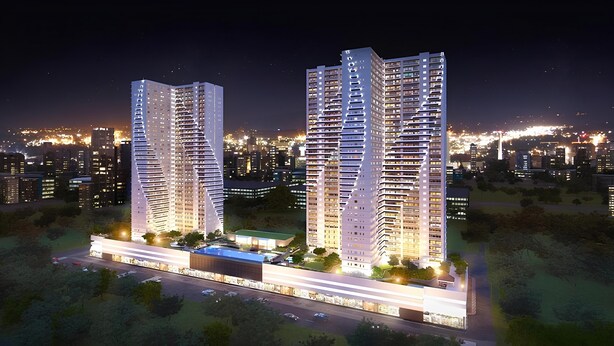 Two high-rise buildings with multiple floors, surrounded by a landscaped area with trees and a parking lot. - Grass Residence T3 34th Floor (Quezon City)