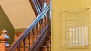 A staircase with a sign indicating the Ground Floor and First Floor. - 3 Bed Cosy Loft Space Apartment - Free On-Site Parking (Bowness-on-Windermere)